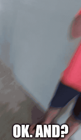 A Man In A Red Shirt Is Covering His Mouth With His Hand And Says Ok And GIF