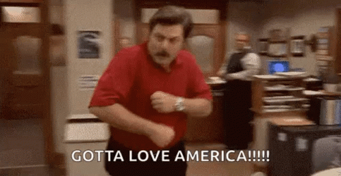 A Man In A Red Shirt Is Dancing In A Room With The Words `` Gotta Love America '' Written On The Bottom . GIF