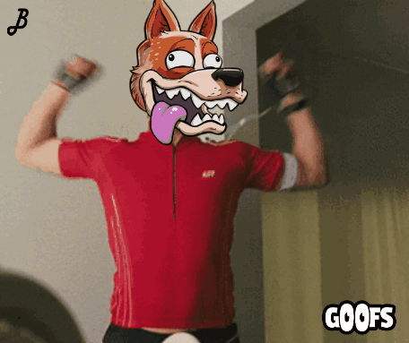 A Man In A Red Shirt Is Flexing His Muscles With A Cartoon Fox On His Head And The Words Goofs Below Him GIF