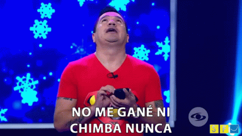 A Man In A Red Shirt Is Holding A Cell Phone And Saying No Me Gane Ni Chimba Nunca . GIF