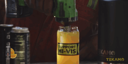 A Man In A Red Shirt Is Holding A Hammer In Front Of A Cabinet That Has The Word Tekam On It GIF