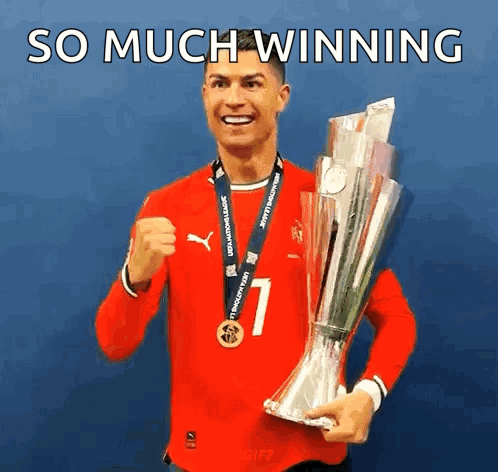 A Man In A Red Shirt Is Holding A Trophy With The Words So Much Winning Below Him GIF
