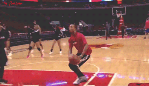 A Man In A Red Shirt Is Jumping For A Basketball GIF