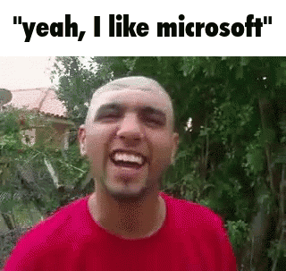 A Man In A Red Shirt Is Laughing With The Words `` Yeah , I Like Microsoft '' Above Him . GIF