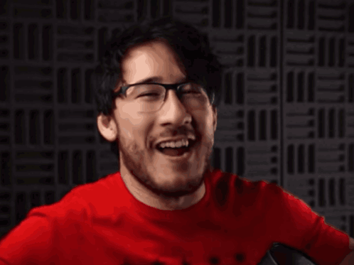 A Man In A Red Shirt Is Making A Funny Face GIF