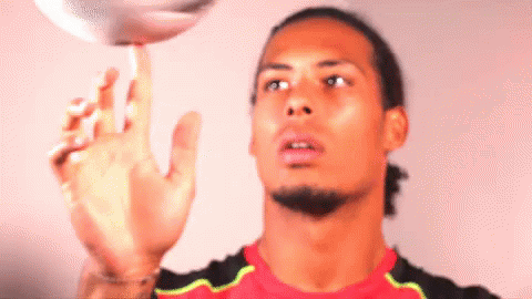 A Man In A Red Shirt Is Playing With A Ball GIF