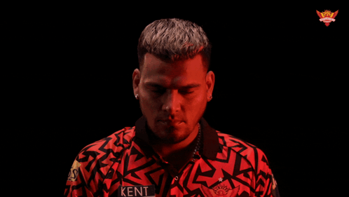 A Man In A Red Shirt Is Pointing At Something GIF