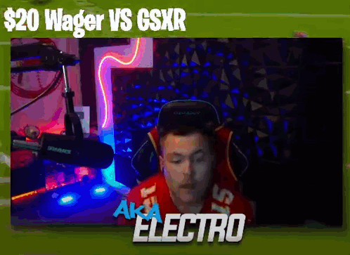 a man in a red shirt is sitting in front of a microphone with the words wager vs gsxr above him .