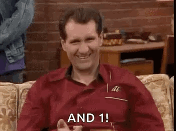 Man In Red Shirt Sitting On Couch Smiling With Phone GIF