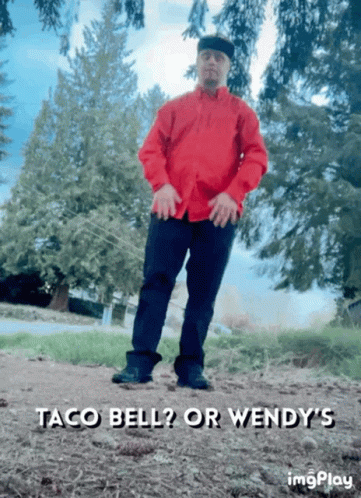 A Man In A Red Shirt Is Standing In A Field With The Words Taco Bell Or Wendy 'S Written Below Him GIF