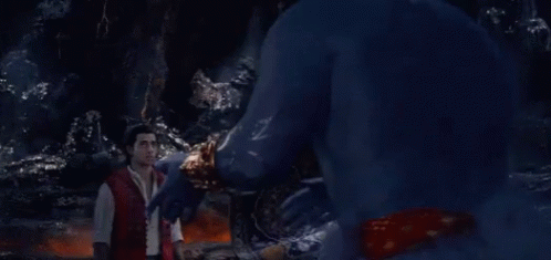 A Man In A Red Shirt Is Standing In Front Of A Blue Monster GIF