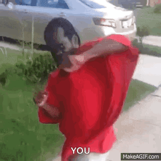 A Man In A Red Shirt Is Standing In Front Of A White Car And Says You . GIF