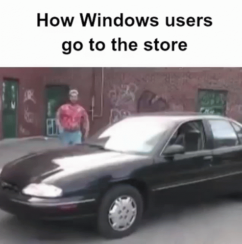 A Man In A Red Shirt Is Standing Next To A Black Car That Says How Windows Users Go To The Store GIF