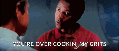 A Man In A Red Shirt Is Talking To Another Man And Says You 'Re Over Cookin My Grits . GIF