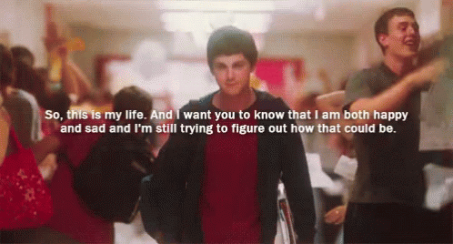 A Man In A Red Shirt Is Walking Down A Hallway With A Quote On The Bottom GIF