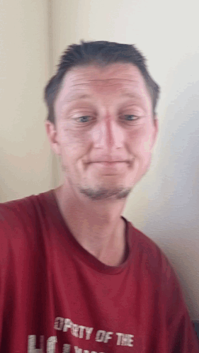 A Man In A Red Shirt That Says Property Of The GIF