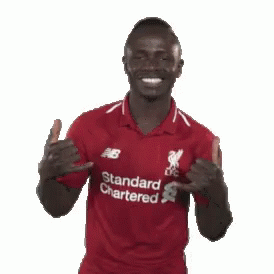 A Man In A Red Shirt That Says Standard Chartered On It GIF