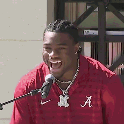 a man in a red shirt with the letter a on it