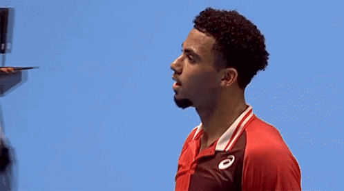 A Man In A Red Shirt With The Letter A On The Front GIF
