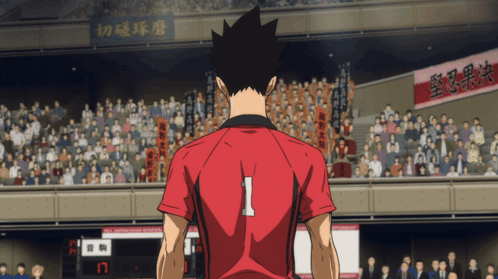 A Man In A Red Shirt With The Number 1 On The Back Stands In Front Of A Crowd GIF