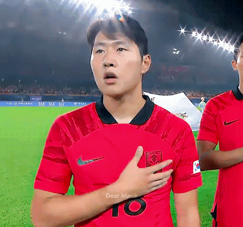 A Man In A Red Shirt With The Number 10 On It Stands On A Field GIF