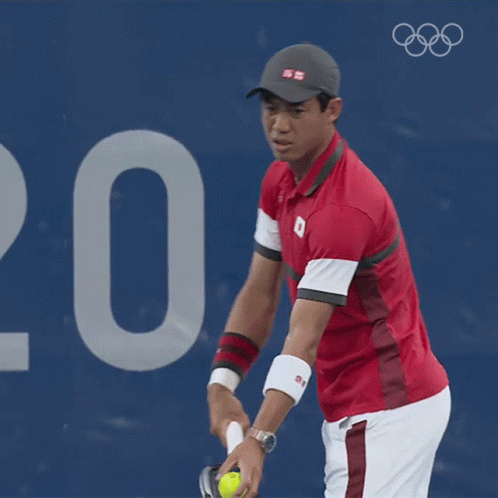 A Man In A Red Shirt With The Number 8 On It Is Playing Tennis GIF
