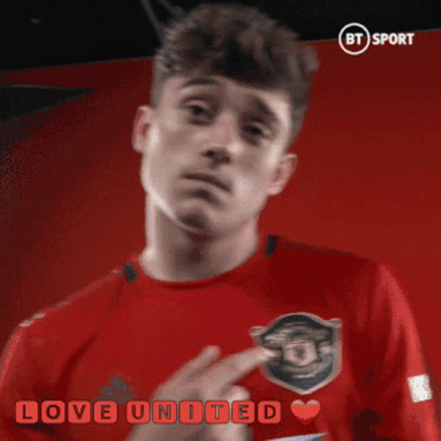a man in a red shirt with the words love united written on it