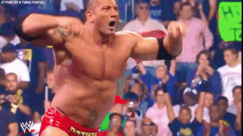 A Man In A Red Shorts Is Standing In Front Of A Crowd . GIF