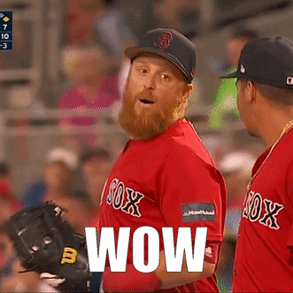 A Man In A Red Sox Jersey Says Wow In Front Of Another Man GIF