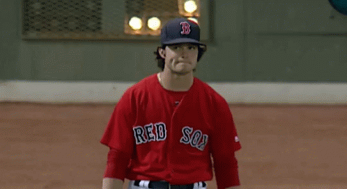 A Man In A Red Sox Jersey Stands On The Field GIF