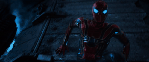 A Man In A Red Spiderman Costume Is Running In The Dark GIF
