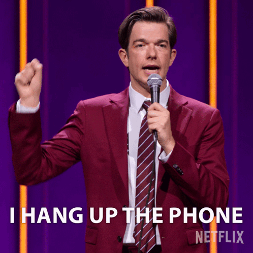 A Man In A Red Suit And Tie Is Holding A Microphone And Says I Hang Up The Phone GIF