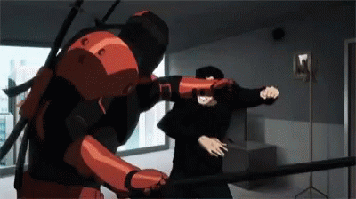 A Man In A Red Suit Is Fighting Another Man In A Black Suit . GIF