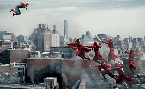A Man In A Red Suit Is Flying Through The Air In Front Of A City GIF