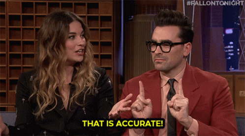 A Man In A Red Suit Says That Is Accurate While Talking To A Woman GIF