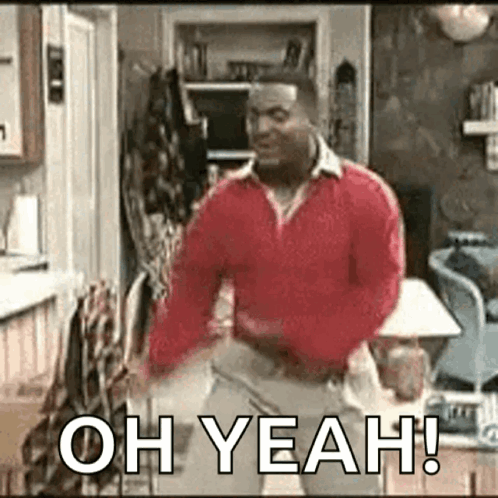 A Man In A Red Sweater Is Dancing In A Living Room And Saying Oh Yeah . GIF
