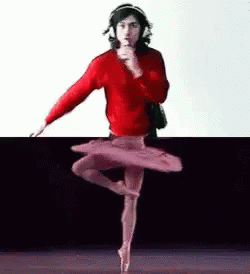 A Man In A Red Sweater Is Dancing In A Tutu While Wearing Headphones . GIF
