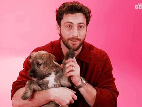 Man In Red Sweater Holding Puppy Buzzfeed Logo GIF