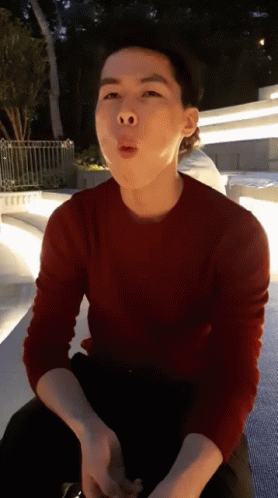 A Man In A Red Sweater Is Making A Face GIF