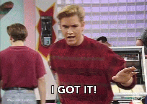 A Man In A Red Sweater Is Saying `` I Got It '' While Standing In Front Of A Machine . GIF
