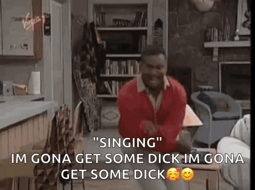 A Man In A Red Sweater Is Singing In A Living Room .. GIF