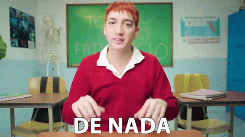 A Man In A Red Sweater Is Sitting At A Desk In Front Of A Chalkboard That Says Proyecto GIF