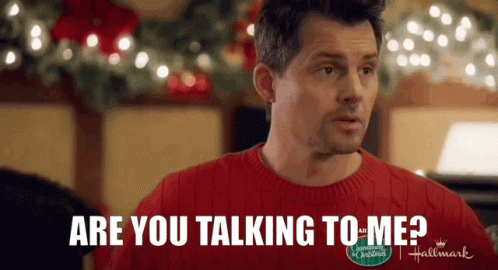 A Man In A Red Sweater Is Talking To Another Man In A Hallmark Christmas Movie . GIF
