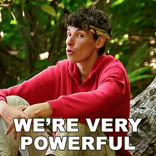 A Man In A Red Sweatshirt Sits On A Tree Trunk With The Words " We 'Re Very Powerful " Written Below Him GIF