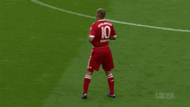 a man in a red t-mobile jersey stands in front of a crowd