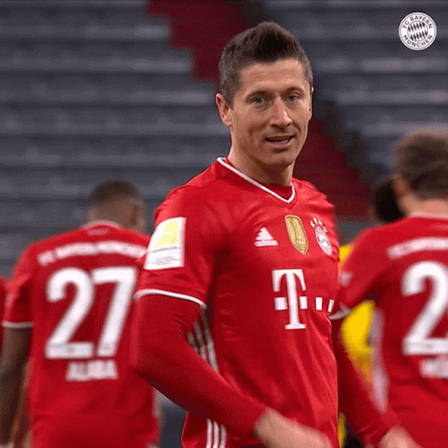 A Man In A Red T-Mobile Jersey Stands In Front Of A Group Of Soccer Players GIF