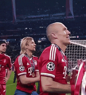 a man in a red t-mobile jersey stands next to another man
