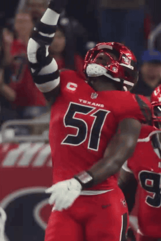 A Man In A Red Texans Jersey Holds Up His Arms GIF