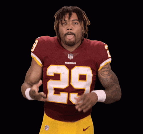 A Man In A Redskins Jersey With The Number 29 On His Chest GIF