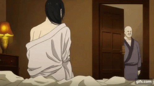 A Man In A Robe Is Standing In A Doorway Next To A Woman In A White Robe . GIF